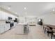 Bright and airy kitchen featuring white cabinets, stainless steel appliances, and an island with seating at 2047 Rosewood Cir, Lakeland, FL 33810