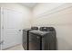 Modern laundry room with full-size washer and dryer and wire shelving at 2047 Rosewood Cir, Lakeland, FL 33810