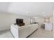 Bright living room featuring a sectional sofa, open floor plan, and seamless transition to the kitchen and dining area at 2047 Rosewood Cir, Lakeland, FL 33810