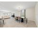 Bright, open-concept living and dining area featuring neutral colors, tile floors, and modern chandelier at 2047 Rosewood Cir, Lakeland, FL 33810