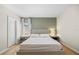 Serene main bedroom showcasing a soft green accent wall, stylish nightstands, and elegant curtains for a calming retreat at 2047 Rosewood Cir, Lakeland, FL 33810