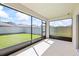 Enclosed patio overlooking the fenced backyard with green grass and clear blue sky at 2047 Rosewood Cir, Lakeland, FL 33810