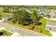 Street view showing a grassy lot, mature trees and a bench in a neighborhood setting at 2047 Rosewood Cir, Lakeland, FL 33810