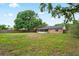 A sprawling lawn behind the brick facade and screened in lanai at 2322 Northview Dr, Lakeland, FL 33810