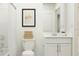 A clean, bright bathroom with white fixtures, a shower-tub combo, and minimalist decor for a fresh and modern feel at 1261 Deepwater Cir, Eagle Lake, FL 33839