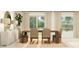 Elegant dining space featuring a wooden table, neutral chairs, and natural light from large windows at 1261 Deepwater Cir, Eagle Lake, FL 33839
