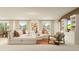 Spacious living room with a modern sectional sofa, decorative pillows, and ample natural light at 1261 Deepwater Cir, Eagle Lake, FL 33839