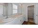 Bathroom with dual sinks, granite countertops, and walk-in shower at 1538 Sage Ave, Haines City, FL 33844