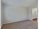 Neutral bedroom with carpet flooring and door to ensuite bathroom at 1538 Sage Ave, Haines City, FL 33844