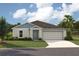 Charming single-story home featuring a two-car garage and lush green lawn at 1538 Sage Ave, Haines City, FL 33844