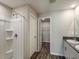 Bathroom featuring a shower, white cabinets, and view into the walk-in closet at 1542 Sage Ave, Haines City, FL 33844