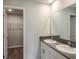 Modern bathroom with double sinks, white cabinets, and a view into the walk-in closet at 1542 Sage Ave, Haines City, FL 33844