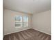 Bright bedroom with neutral walls, plush carpeting, and dual windows for ample natural light at 1542 Sage Ave, Haines City, FL 33844