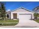 Charming single-story home with a well-manicured lawn and a two-car garage on a sunny day at 1542 Sage Ave, Haines City, FL 33844