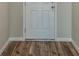 Hallway featuring a white door and wood-style flooring at 1542 Sage Ave, Haines City, FL 33844