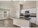 Open kitchen with white cabinets, stainless appliances, an island, and a large living space at 1542 Sage Ave, Haines City, FL 33844
