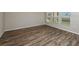 Bright living room with wood-look floors and several windows providing lots of light at 1542 Sage Ave, Haines City, FL 33844