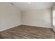 A spacious living room with modern flooring and a window, providing lots of natural light at 1542 Sage Ave, Haines City, FL 33844
