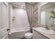 This clean bathroom features a shower-tub combination with bright white tiles and contemporary fixtures at 1566 Sage Ave, Haines City, FL 33844