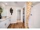 This luxurious bathroom offers a dual sink vanity, wooden-look flooring, and a spacious walk-in shower at 1566 Sage Ave, Haines City, FL 33844