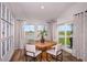Dining area with modern decor, wood table, and sliding glass door leading to backyard with pond view at 1566 Sage Ave, Haines City, FL 33844