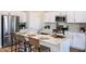 Open kitchen featuring stainless steel appliances, quartz countertops, and a breakfast bar with seating at 1566 Sage Ave, Haines City, FL 33844