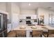 Open kitchen with quartz countertops, stainless steel appliances, a breakfast bar and bright white cabinetry at 1566 Sage Ave, Haines City, FL 33844