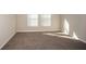 Neutral bedroom featuring plush carpeting and natural light from the two window at 1570 Sage Ave, Haines City, FL 33844