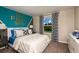Bright bedroom with blue and white color scheme, large window with neighborhood views at 1574 Sage Ave, Haines City, FL 33844