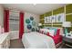 Stylish bedroom with bright colors, fun wall art, and a comfortable bed at 1574 Sage Ave, Haines City, FL 33844