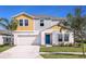 Charming two-story home with a bright blue front door and manicured landscaping at 1574 Sage Ave, Haines City, FL 33844