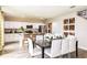 Eat-in kitchen with white cabinets, stainless steel appliances, island, and dining area at 1574 Sage Ave, Haines City, FL 33844