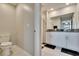 Well-lit bathroom featuring tiled floors, white cabinetry and granite countertops at 1792 Yellow Trl, Lakeland, FL 33801