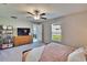 Well-lit bedroom features plush carpeting, a dresser with television, and a bright window at 1792 Yellow Trl, Lakeland, FL 33801