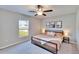 Bright bedroom featuring a comfortable bed with soft bedding, a ceiling fan and large windows at 1792 Yellow Trl, Lakeland, FL 33801