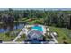 Aerial view of the community pool, clubhouse, and lush landscaping at 1792 Yellow Trl, Lakeland, FL 33801