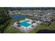 Aerial view of the community pool with umbrellas and lounge chairs at 1792 Yellow Trl, Lakeland, FL 33801