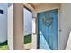 Close up of charming blue front door with decorative wreath and 'welcome' sign at 1792 Yellow Trl, Lakeland, FL 33801