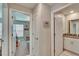 Hallway leading to a bedroom and a bathroom with neutral walls and white trim at 1792 Yellow Trl, Lakeland, FL 33801