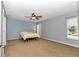 Spacious bedroom features a ceiling fan, plush carpeting and plenty of natural light at 15213 Sw 14Th Avenue Rd, Ocala, FL 34473