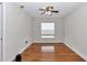 Cozy bedroom features hardwood floors, a ceiling fan and a window for natural light at 15213 Sw 14Th Avenue Rd, Ocala, FL 34473