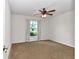 Comfortable bedroom with plush carpeting and a large window at 15213 Sw 14Th Avenue Rd, Ocala, FL 34473