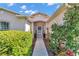 Inviting walkway leading to the front door, framed by vibrant greenery and colorful flowers at 15213 Sw 14Th Avenue Rd, Ocala, FL 34473