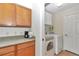 Bright laundry area boasts cabinets, washer, dryer and tile flooring at 15213 Sw 14Th Avenue Rd, Ocala, FL 34473