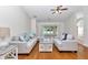 Comfortable living room with plush sofas and sliding glass doors to outdoor space at 15213 Sw 14Th Avenue Rd, Ocala, FL 34473