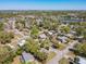 A picturesque neighborhood offering a mix of homes, lush greenery, and a serene lake view under clear blue skies at 218 W Magnolia St, Clermont, FL 34711