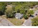 Aerial view of a home on a corner lot, showcasing the lush landscaping and neighborhood surroundings at 218 W Magnolia St, Clermont, FL 34711