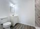 Bathroom showcasing a toilet, modern vanity, and a shower with a marble tile surround at 218 W Magnolia St, Clermont, FL 34711