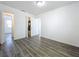 A bedroom boasts wood-look floors and neutral walls at 218 W Magnolia St, Clermont, FL 34711