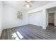 A bedroom features wood-look flooring, natural light from a window, and neutral walls at 218 W Magnolia St, Clermont, FL 34711